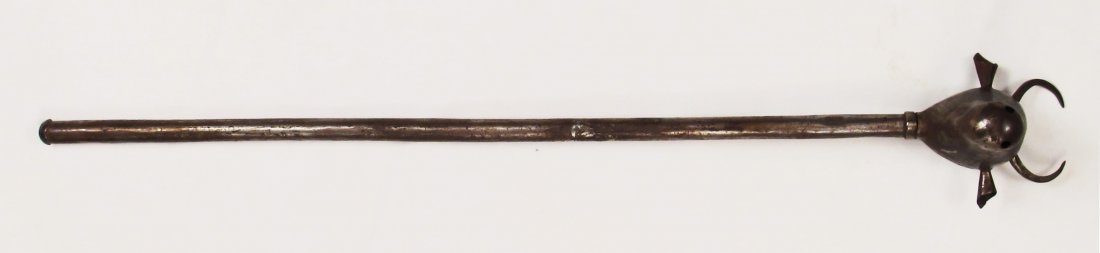A PERSIAN MACE: Of steel, the head forged in the form of a bull’s head. 19th-20th century. Areas of rust. Overall length 72.1cm. Condition II