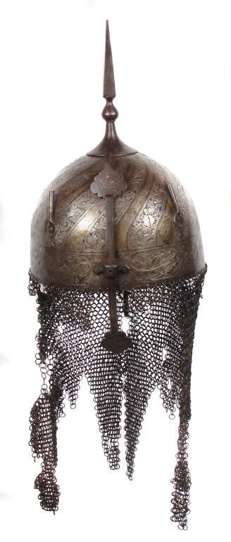 A PERSIAN KULA KHUD HELMET: Of characteristic hemispherical form with top spike, adjustable nasal bar, and plume tubes, embellished with engraved bands of spiral flowering vines highlighted in gold, the broad borders containing
