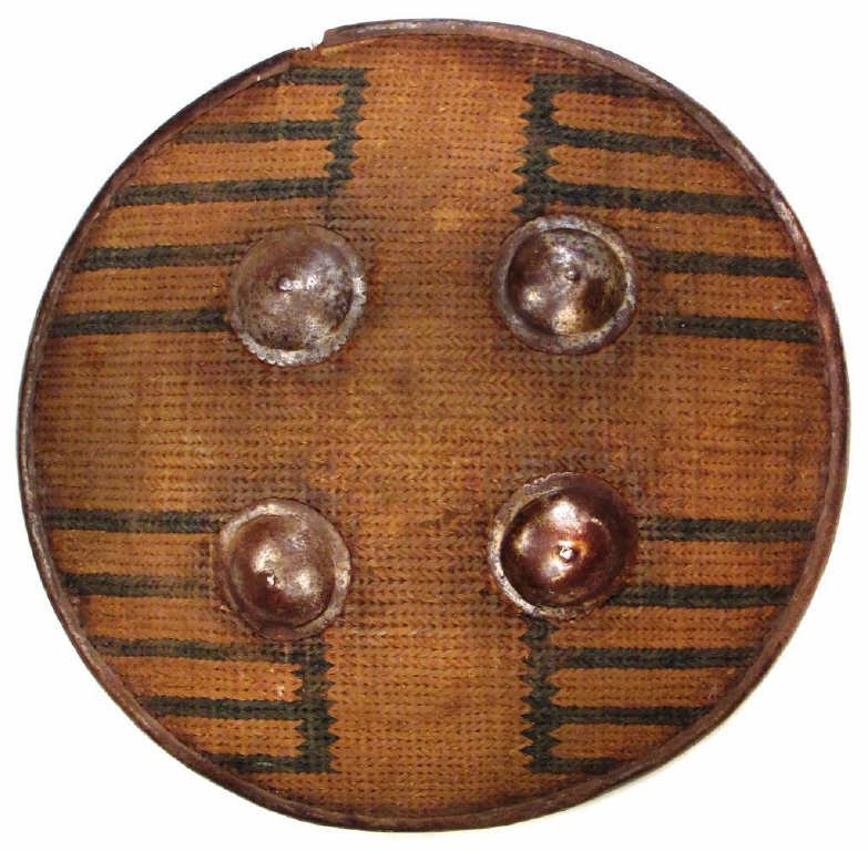A RARE AFGHAN SIPAR SHIELD: Lightly-domed and composed of thick cording on a metallic weft in yellow with prominent geometrical designs in blue, with iron rim and four steel bosses, the reverse with remains of original grips and