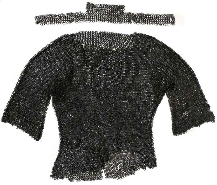 A MUGHAL MAIL SUIT: Comprising a coat, collar and breeches, wrought in alternating rows of heavy riveted and solid rings. The collar with raised nape section, coat with half-sleeves, the breeches with cuffs pointed to co