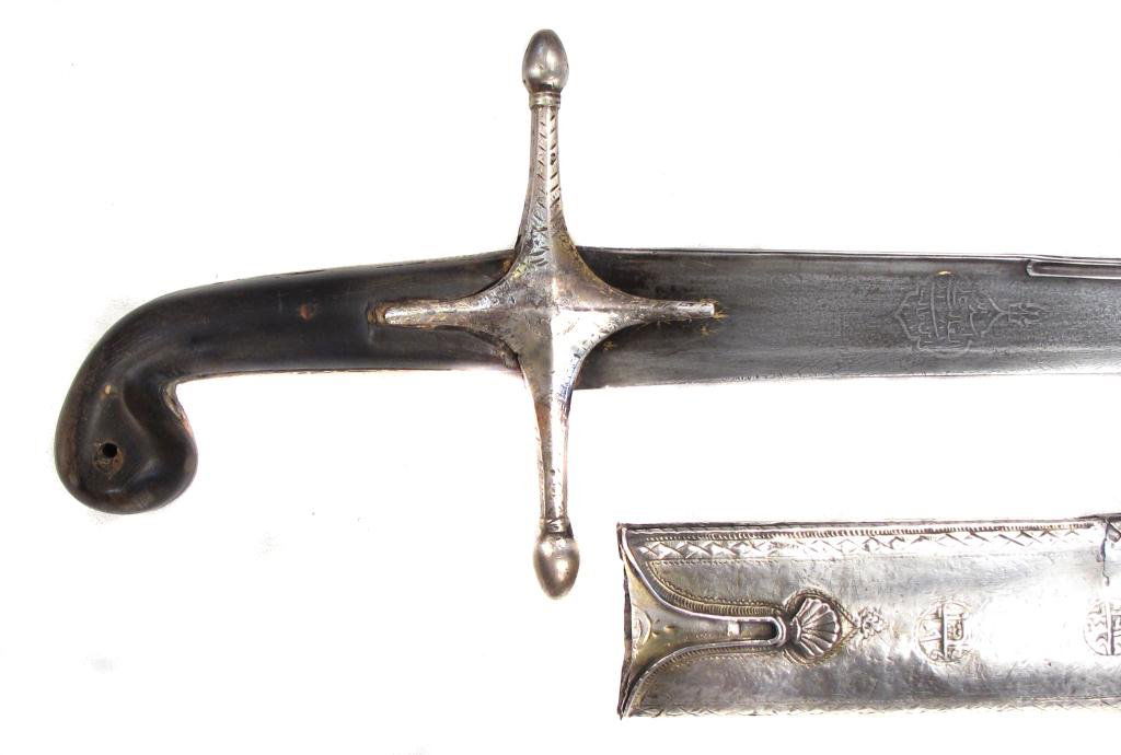 AN OTTOMAN PALA SABER: Of classic form, the grips with rolled pommel and silver mounts, elegantly engraved with Ottoman geometrical-motif borders and circular cartouches containing Arabic inscriptions. The broad, T-section