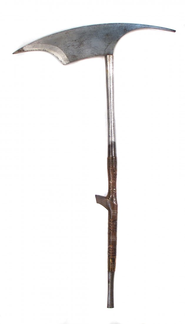 A PHILIPPINES KALINGA HEAD AXE: Bontok workmanship, the handforged steel head of typical form, the wooden haft embellished with pierced and punched brasswork, with long iron ferrule and chape. Light wear. Late 19th –early 20th cen