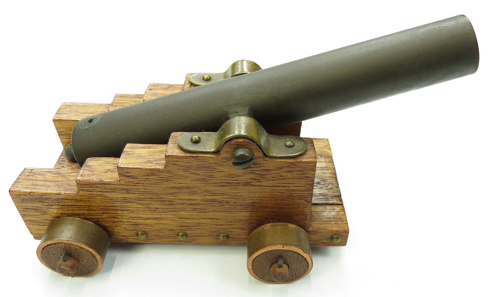 A BLACK POWDER MODEL NAVAL CANNON: With heavy bronze tube, on its hardwood carriage with brass hardware. 20th century. Minor wear. Overall length 16.5cm/ 6 1/2 inches. Condition II