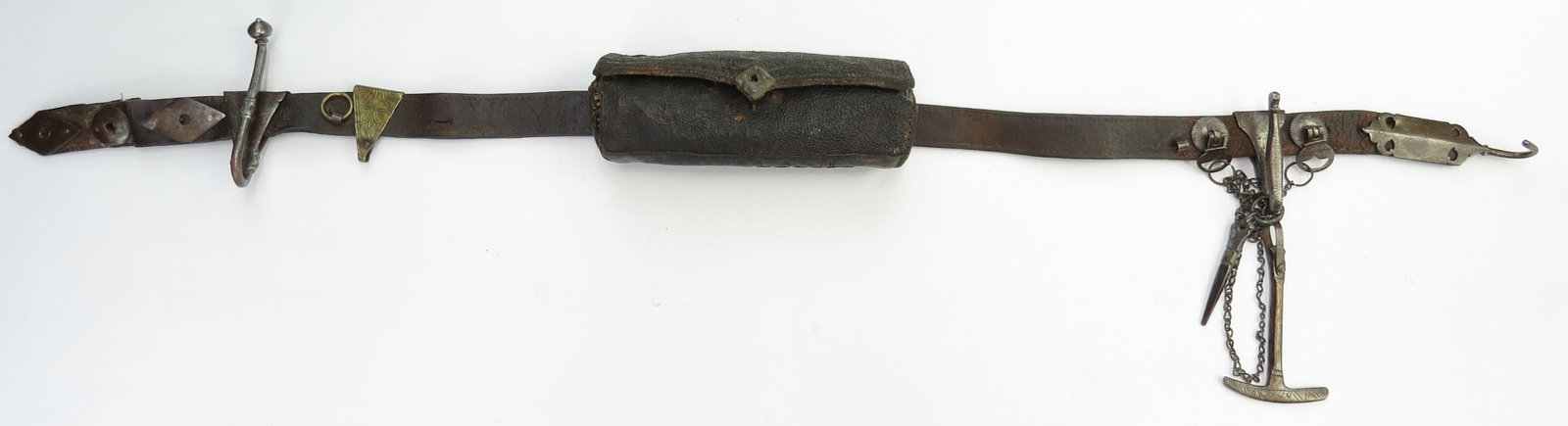 AN AFGHAN WARRIORS BELT: An older example, with fine, profiled steel mounts and hide band and an embroidered bullet container, sword hook, chain-captured musket tool and pan prick. 18th- 19th century. Minor wear. Overall leng