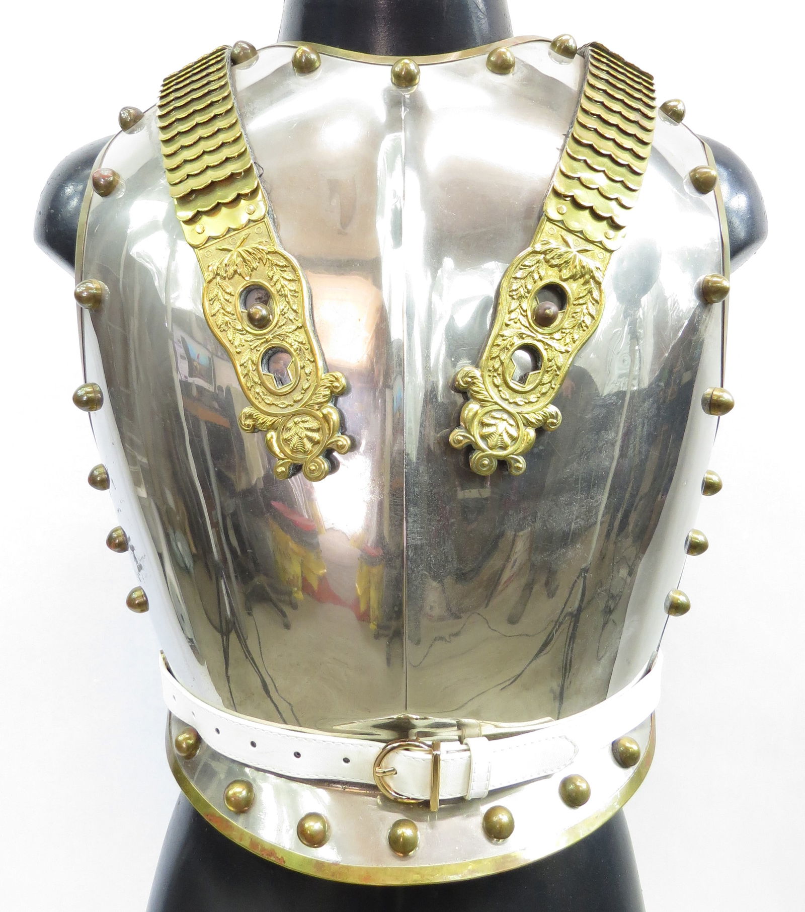A STEEL CUIRASS OF THE BRITISH ROYAL LIFE GUARDS: Comprising a steel breast and backplate, highly polished and set with large brass studs about the periphery. Retains its shoulder straps set with brass plates, terminating in elaborately modeled brass