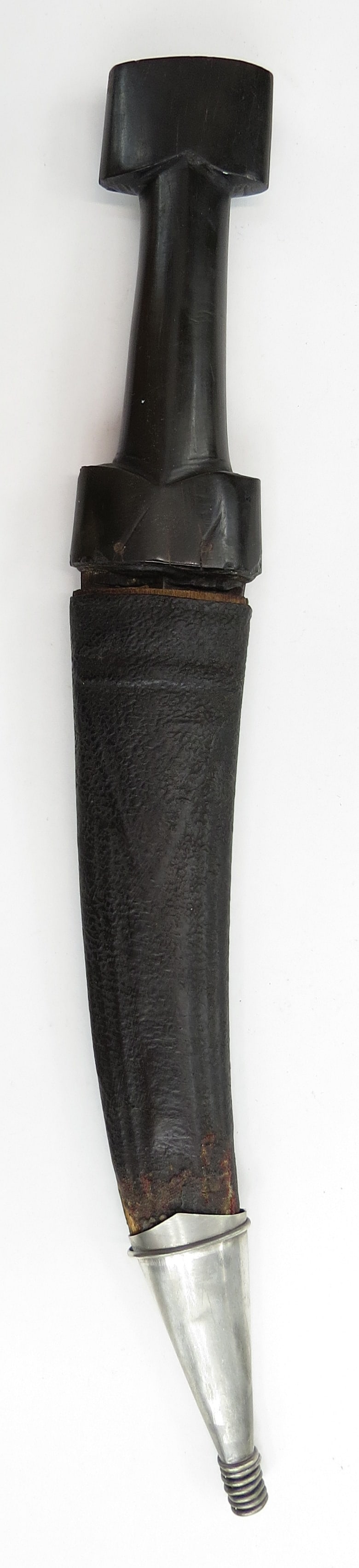 A KURDISH KHANJAR DAGGER: The grip of typical form, carved of a single section of dark horn, the heavy blade lightly curved and double-edged, wrought of actively-patterned wootz steel. In its tooled, leather-covered wooden sca