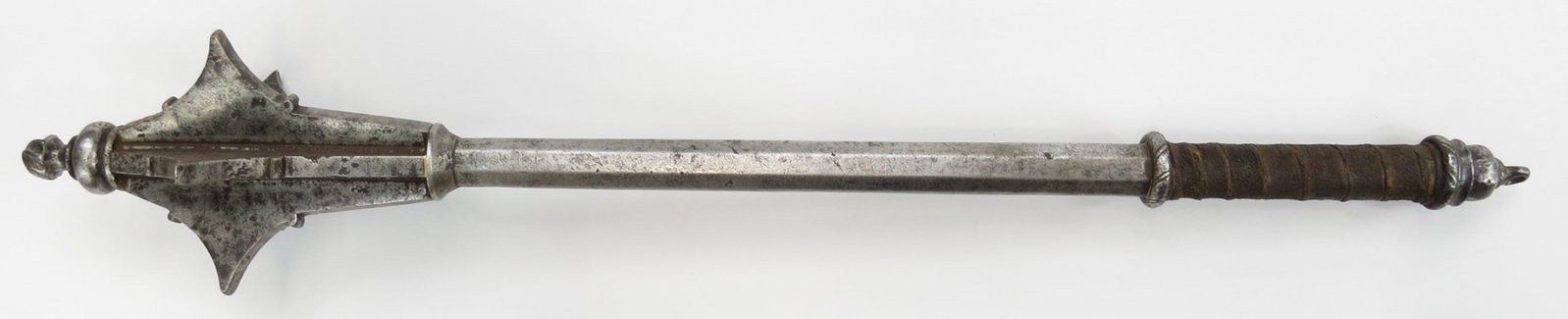 A RARE GOTHIC MACE: Displaying the simple elegance of Italian work, wrought entirely of steel, the head composed of six massive profiled steel flanges, each flange slotted and brazed to the tapering octagonal haft, which