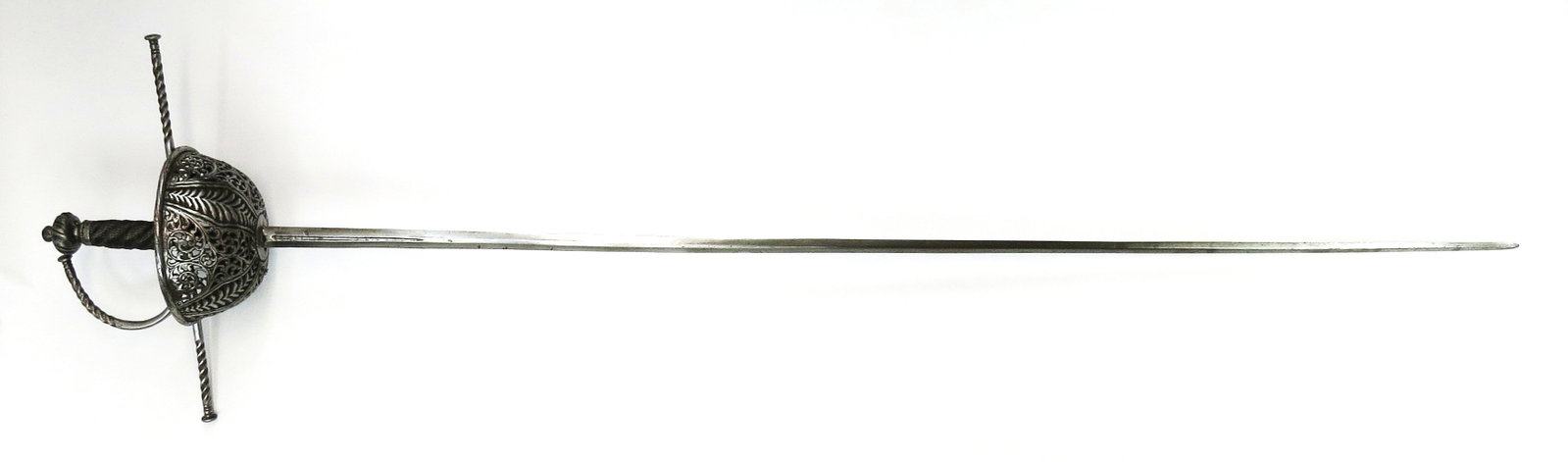 A SPANISH CUPHILT RAPIER SWORD: The cup well chiseled and pierced with alternating panels of vine and leaf work throughout, with long, wrenched quillons and knucklebow and intact guardapolvo, the pommel chiseled en suite. Grip retai