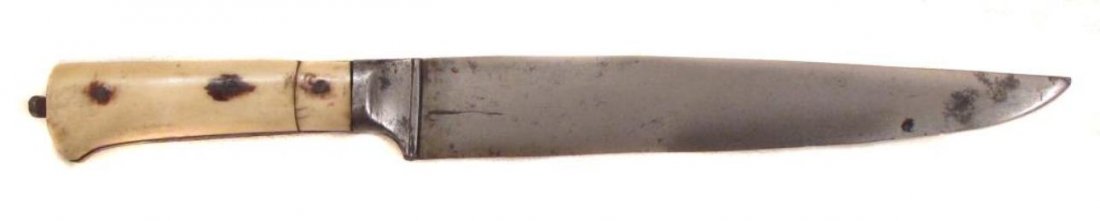 A MUGHAL KARD DAGGER: Of characteristic form with elephant grips, the broad blade forged of actively patterned Persian black wootz steel. Mid-18th century. Light wear. Overall length 24.2 cm. Condition II