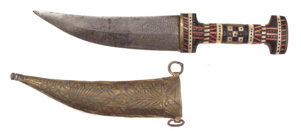 A SYRIAN KHANJAR DAGGER: With inlaid hilt and etched blade.In its brass sheath.Early 20th century.Minor losses.Overall length 34 cm. Condition III