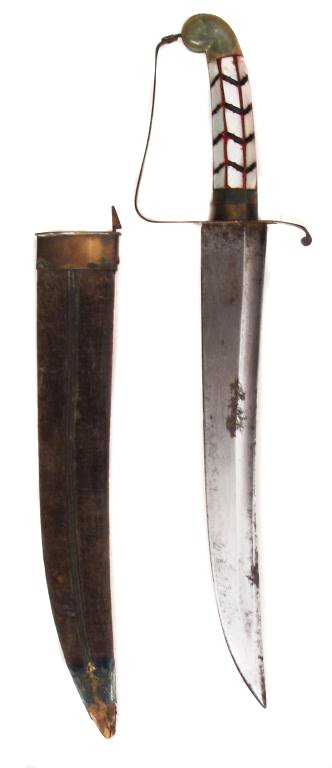 AN ANGLO-INDIAN HUNTING DAGGER: The grip with rolled pommel carved of green hardstone, with mother of pearl panels and brass guard, secured by a latch on the brass locket of the velvet-covered wooden scabbard. With broad, curved, si