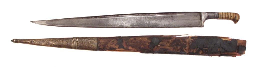 AN AFGHAN KHYBER KNIFE: With horn grips and heavy blade.In its wooden scabbard.Mid-19th century. Worn, leather deteriorated. Overall length 80.5 cm. Condition IV
