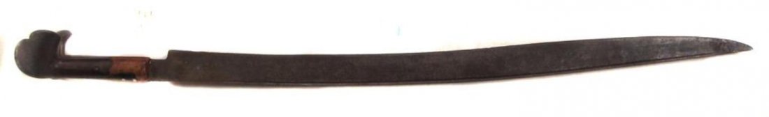 AN OTTOMAN YATAGHAN SWORD: Balkan work, the horn grips with large ears and single-edged recurved blade with fuller at the spine. 19th century. Bolsters lacking, blade lightly pitted. Overall length 72.7 cm. Condition III