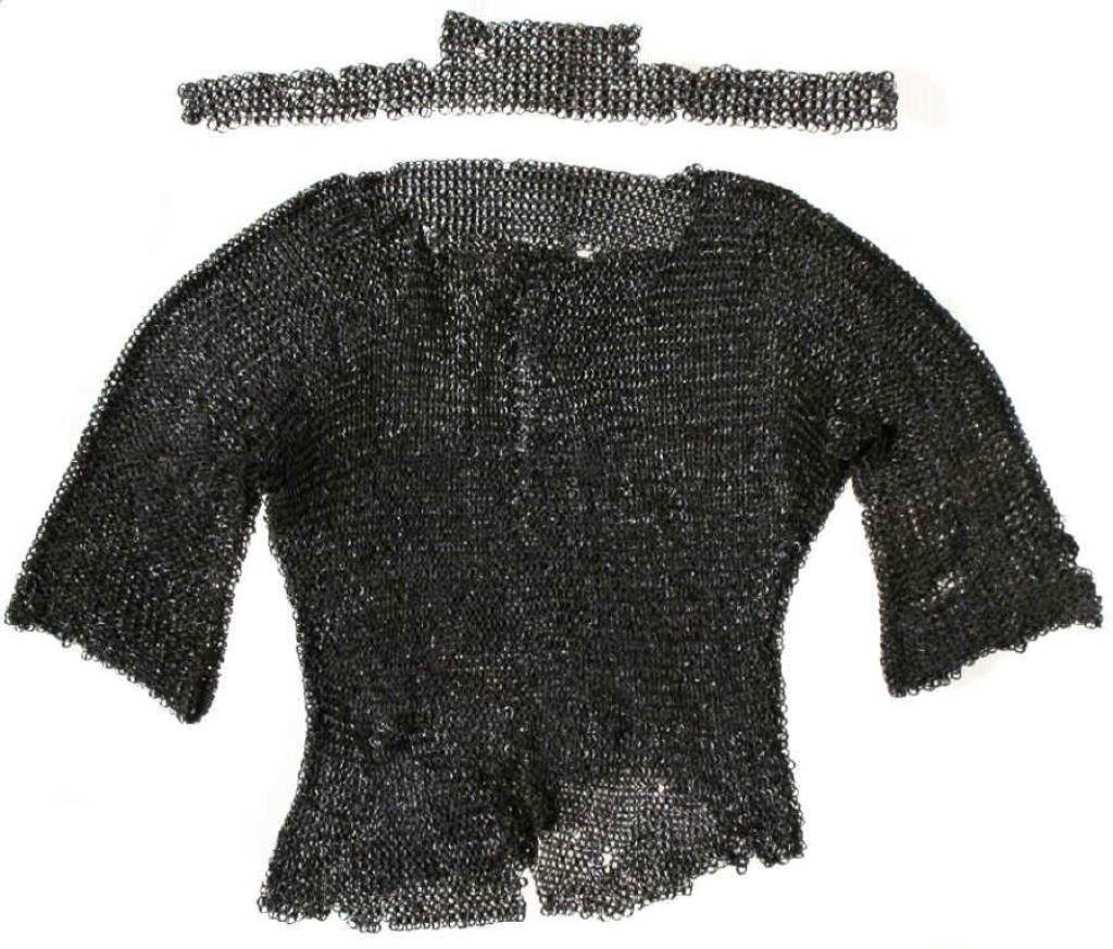 A MUGHAL MAIL SUIT: Comprising a coat, collar and breeches, wrought in alternating rows of heavy riveted and solid rings. The collar with raised nape section, coat with half-sleeves, the breeches with cuffs pointed to co