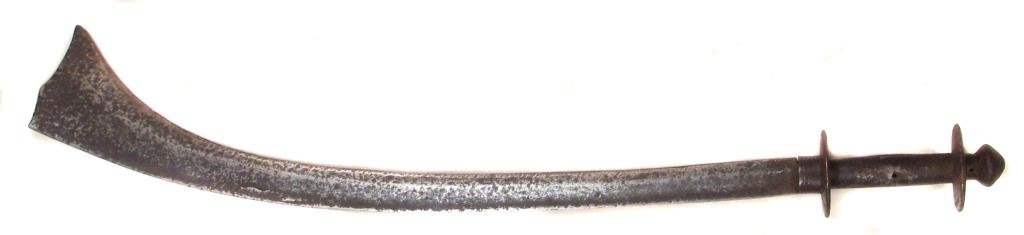 A NEPALESE KORA SWORD: With disk pommel and guard, blade flares strongly at the tip. Mid-late 17th century. Worn, pitted. Overall length 69 cm. Condition IV