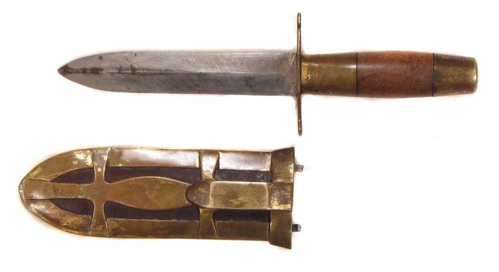 AN AMERICAN BOOTKNIFE: The short, straight, double-edged blade with evidence of sharpening, the brass mounts well profiled and fitted with a beltclip, possibly Native American work, possibly representing a turtle totem. Mid