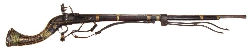 AN AFGHAN FLINTLOCK JEZAIL MUSKET: An unusually complete example of First Afghan War era, the stock of characteristic form and heavily embellished in engraved brass. The captured British lock with East India Company mark and the maker?