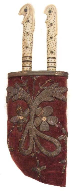 A BOSNIAN TROUSSE: Comprising a knife with SARAJEVO inlaid in silver on the blade and a fork with silver inlay to the base, the matching bone grips with hooked pommels and elaborate brass stud and rosette inlays. In the
