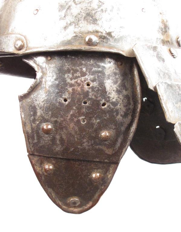 A RARE EASTERN EUROPEAN SZYSZAK HELMET: Hungarian or Polish work, an earlier form than typically encountered. The domed, handforged two-piece bowl with applied, riveted peak with adjustable nasal with flared and profiled terminals, and reta
