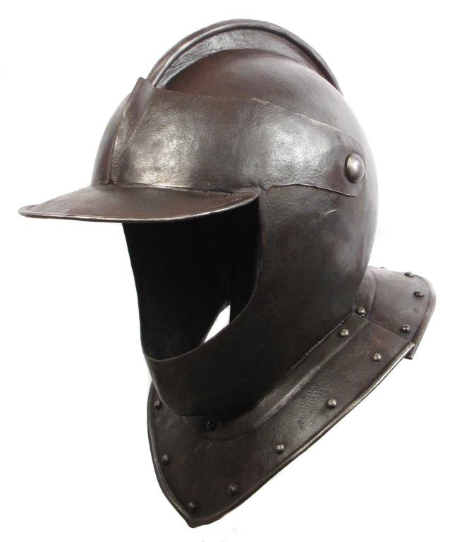 AN ENGLISH BURGONET HELMET: With one-piece skull and rolled comb, the peaked visor and bevor sharing a common pivot as is typical, the bevor secured by a hook. With plume tube to the base of the skull.17th century or later.Light