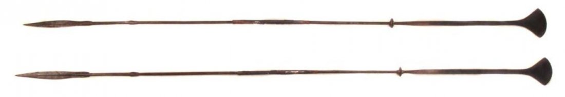 A PAIR OF TUAREG SPEARS: Rarely encountered, wrought entirely of steel with characteristic leaf-shaped heads and flared butts, with filework embellishment and brass disk mounts. Retaining most original leather wrap to grips. 