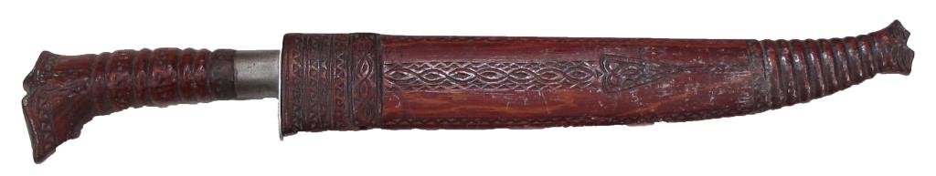 A PHILIPPINES FIGHTING KNIFE: The handle and scabbard of elaborately carved red wood, with broad blade. Mid 20th century._x000D_ Overall length 61.7 cm. _x000D_ Condition II_x000D_
