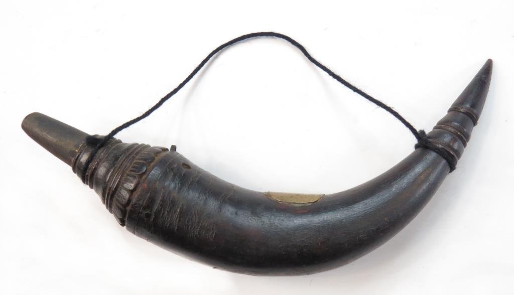 A SOUTHEAST ASIAN POWDERHORN: Probably Burmese, carved of horn with modelled terminals. 19th century. Worn._x000D_ Overall length 24.2 cm. _x000D_ Condition III_x000D_
