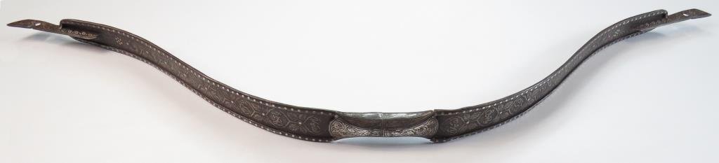 A MUGHAL STEEL BOW: With etched Arabic inscriptions and elaborate borders inlaid in silver. Of break-down construction, with threaded stud at the center of the grip. Probably made for the Delhi Durbars begun in 1877. Lat