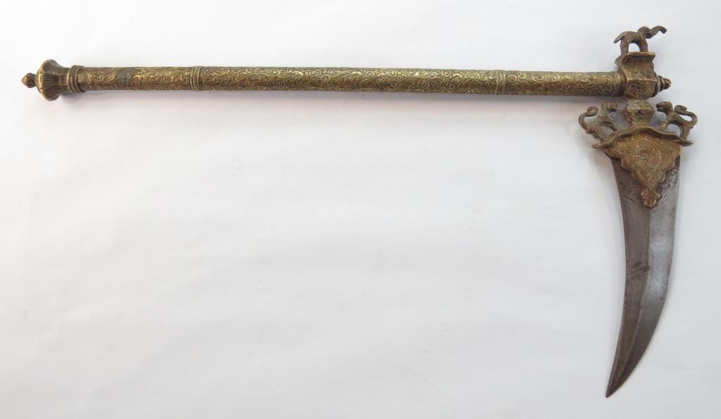 AN INDIAN ZAGHNAL: The curved, double edged blade with strong median ridge, showing traces of a wootz pattern. The haft entirely engraved and gilded, the pommel unscrewing to reveal a straight, single-edged dagger. The 