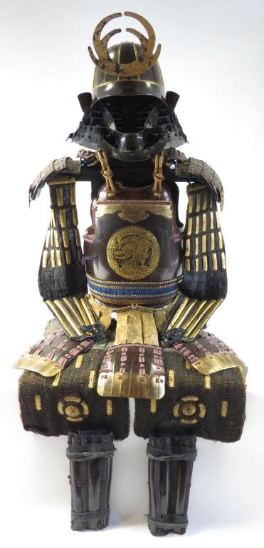 A JAPANESE SUIT OF ARMOR: Edo era, made for a high-ranking samurai. Comprising an 18-plate steel kabuto helmet with dark brown lacquer and gold borders, six steel-plate shikoro and gilded wood maedate in the form of antlers an