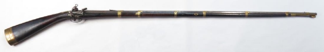 A BALKAN DZEFERDAR MUSKET: An unusually early example of the type, based upon an Italian longarm which evolved in Boka Kotorska. A massive example stocked in dark hardwood, with sloping butt. Mounted in brass, the early lock an