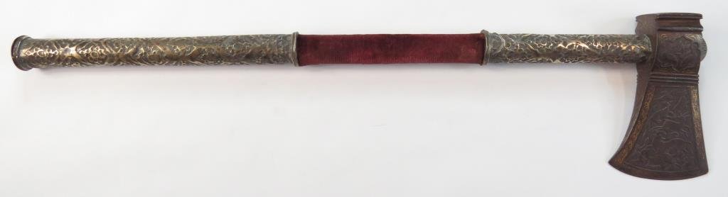 A PERSIAN TABARZIN BATTLEAXE: Zand Dynasty, an example of rare quality. The head finely and delicately chiseled overall with lions hunting various prey, together with birds and gold-inlaid borders. The wooden haft with red velvet 