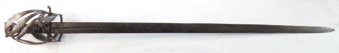 A RARE SCHIAVONA SWORD: The steel basket hilt wrought of characteristic complex profiled strips, curled quillon and integral thumbring, and engraved overall, The fine €œcat€™s head€ form pommel engraved en suite, wi