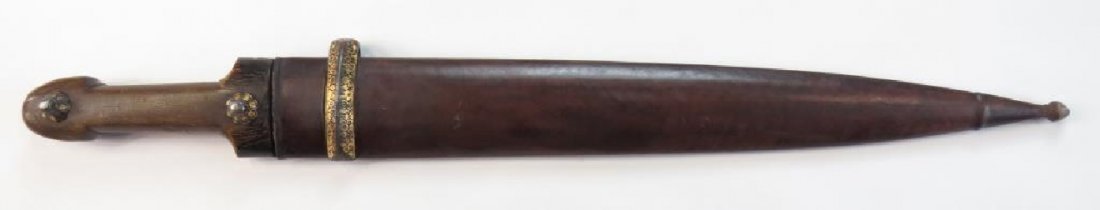 A CAUCASIAN KINDJAL DAGGER: A large example, the grip a single section of fibrous brown horn with gold-inlaid iron bosses. The long, fullered blade wrought of fine pattern-welded steel and struck at the forte with a maker€™s