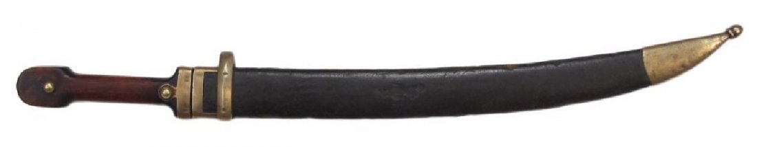 AN IMPERIAL RUSSIAN M1907 BEBUT SHORTSWORD: With hardwood grips, brass mounts and bifullered, curved and double-edged blade. In its original scabbard. Multiple Cyrillic and numerical stamps to blade, hilt and scabbard. Beginning of the 20th cen