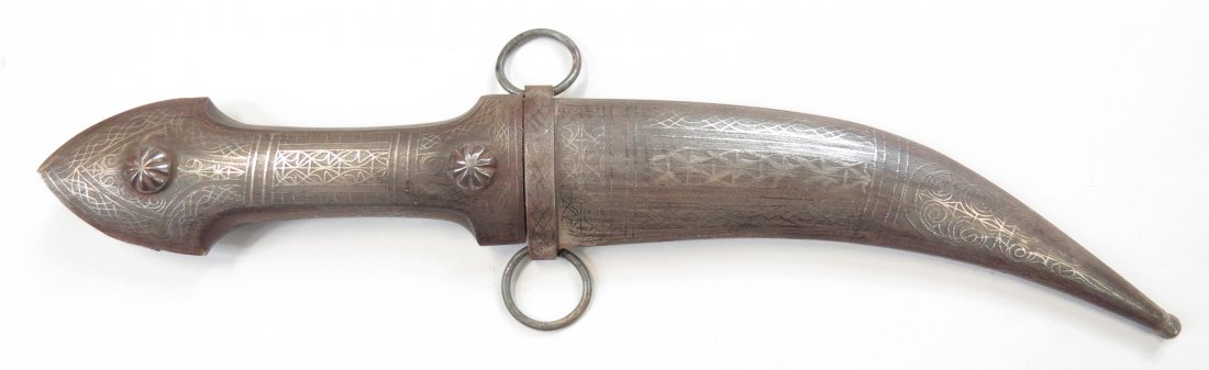 A SYRIAN KHANJAR DAGGER: Of characteristic form, the steel grip and scabbard elaborately inlaid with silver in geometrical motifs. The curved, double-edged blade decorated en suite. Second half of the 19th century. Overall le