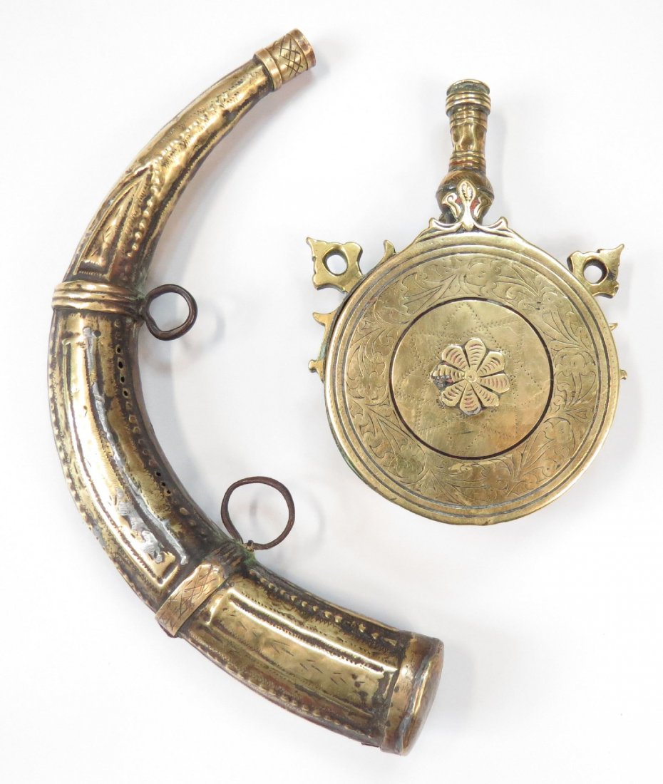 A MOROCCAN POWDER HORN AND FLASK: Both wrought of brass with engraved decoration. 19th century. Overall length of horn 27cm. Condition III