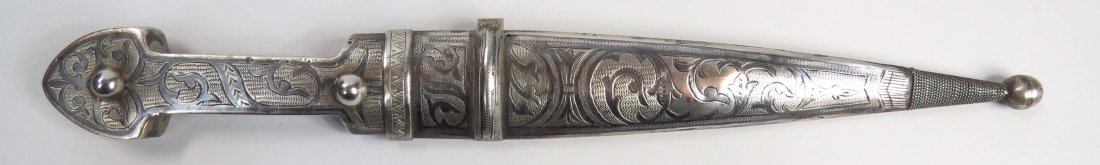 A SYRIAN KHANJAR DAGGER: Showing distinct Circassian influence, the silver mounts finely engraved and nielloed, the reverse of the scabbard with incised Ottoman sultan’s tugra mark. The double-edged blade of symmetrical for