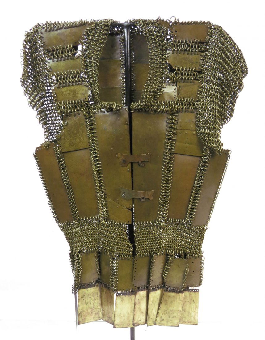 A MORO PLATE AND MAIL ARMOR: Of characteristic form, composed of a series of brass plates intricately interconnected by heavy brass rings, with a pair of large central plates protecting the chest. The short sleeves terminating in