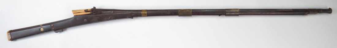 AN INDIAN TORADAR MUSKET: The rosewood stock with elephant breechblock and butt, mounted in profiled steel. The long barrel muzzle flared in lotus form. Early 18th century. Worn. Overall length 152cm. Condition III