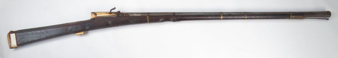 A FINE MUGHAL TORADAR MUSKET: A superb princely firearm, the finely rosewood stock inlaid with engraved silver medallions, with elephant breach block and butt, the trigger and pan with fine flowering vinework in gold. The massive 