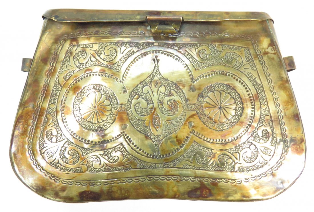 A RARE PANDOUT CARTRIDGE CASE: Seldom encountered. Of brass, with hinged cap and engraved faces. Integral suspension loops. Mid-18th century. Light wear. Overall length 17cm. Condition III