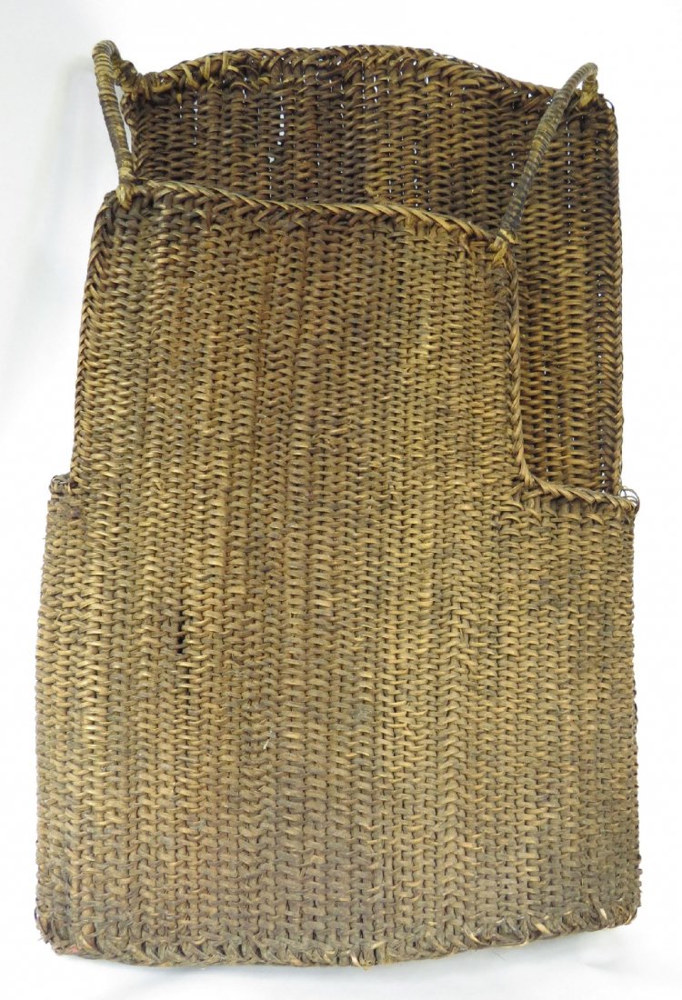 A RARE PAPUA NEW GUINEA CUIRASS: West Sepik, of characteristic form. Tightly woven of thick rattan to allow flexibility in battle, with integral woven shoulder straps. Higher back to protect the wearer from projectiles. With good, de