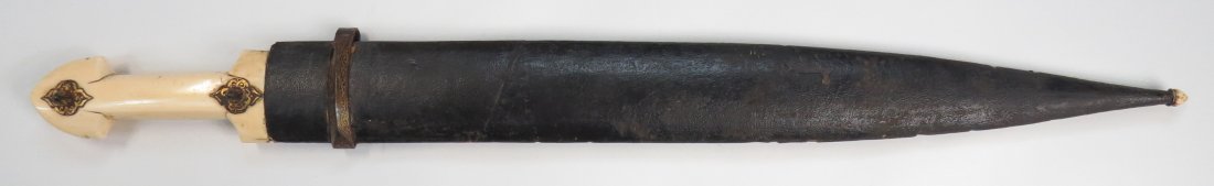 A RARE CAUCASIAN KINDJAL DAGGER: A fine example of Armenian work, the grip carved of a single section of elephant, the steel bosses with scalloped borders intricately inlaid in gold. The massive, double-edged blade rought with single