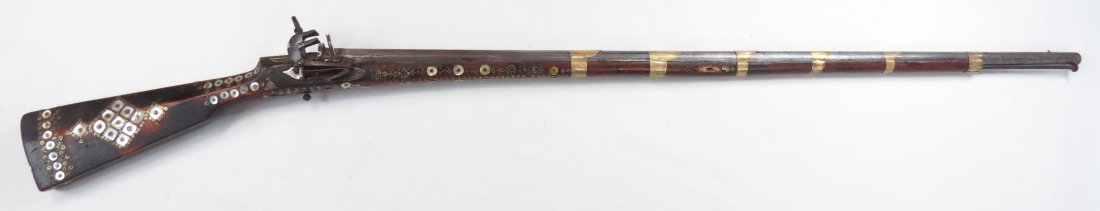 A BALKAN BOYLIYA MUSKET: With hardwood stock of characteristic form, inlaid throughout with mother of pearl roundels, antler panels, and elaborate medallions composed of brass and dark horn, in varying sizes. The distinctive 