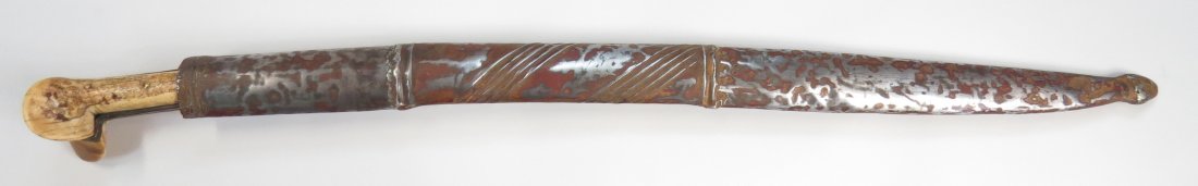 AN OTTOMAN YATAGHAN SWORD: The grips carved of walrus, the gilded mounts with granulated motif. The well-forged blade inlaid in silver on each side; on the left, WORK OF MAHMUD [OWNER] MEHMET ALI BEK (?) YEAR 1224 (1808/09 c.e.