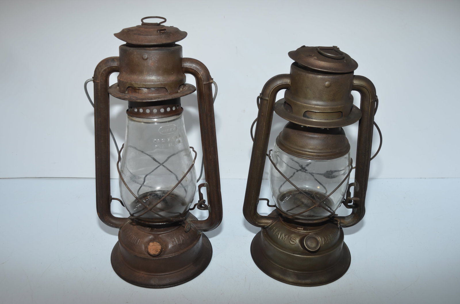 Two C T Ham Lanterns-#2 Cold Blast and Hams Advanced: This is a pair of C T Ham lanterns. The first is cast with NO 2 COLD BLAST on the fount. It has a clear cast replacement Dietz Fitzall globe, correct burner, and is missing its fount cap, which has be
