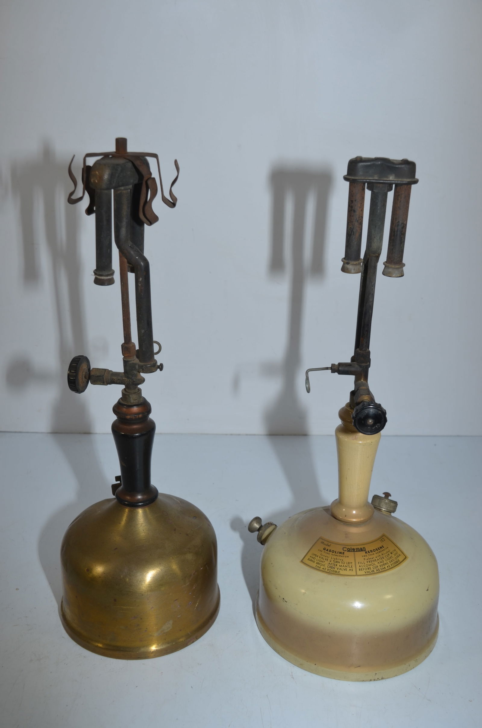 Coleman Model 133 and 152 Lanterns For Parts or Restoration: This is a pair of Coleman lanterns, a Model 133, and a Model 152, which are for parts or restoration. The 133 has a brass fount; the 152 has a manufacturers tag and instructions on the fount