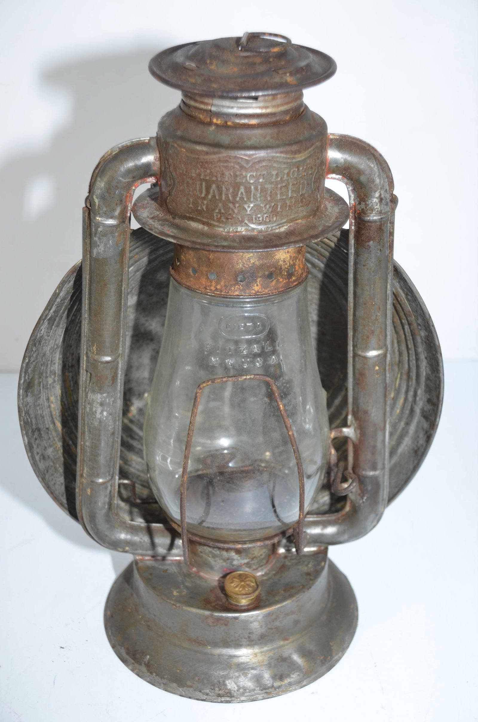 Kemp Tubular Lantern-Toronto, Ontario, Canada: This is a Kemp Tubular Lantern patented in 1900 in Toronto, Ontario, Canada. Cast on the chimney is A PERFECTION LIGHT GUARANTEED IN ANY WIND. The back of the chimney shows KEMP MANUFACTURING CO TORON