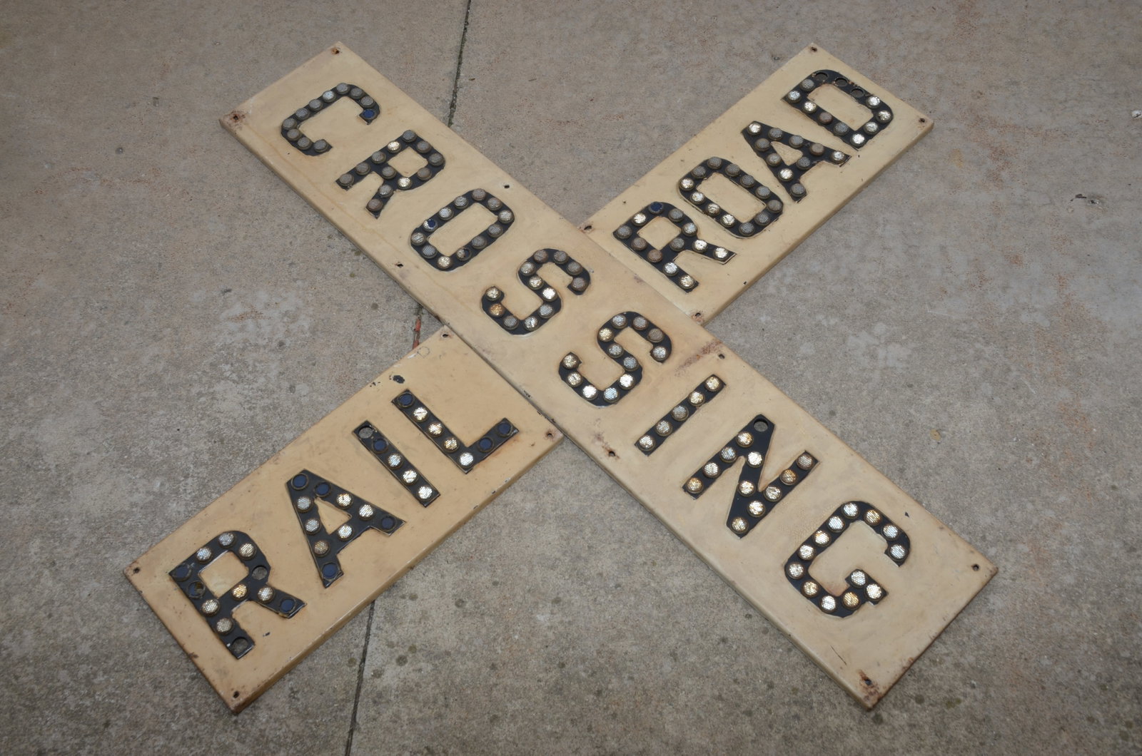 Three Piece Cast Railroad Crossing Sign with Cat Eye Lenses: This is a three piece cast railroad crossing sign with cat eye lenses. Letters are cast, painted black, and have the cat eye lenses. Needs a few replacement lenses. Nice piece.